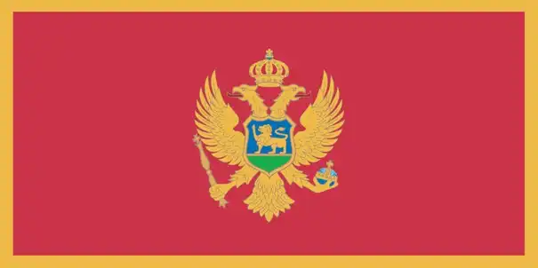 Montenegro’s flag is a red field framed by a narrow gold border, with the national coat of arms—a double‑headed golden eagle holding a scepter and orb, and a shield with a lion—centered. It embodies royal heritage, ecclesiastical tradition, and national identity.