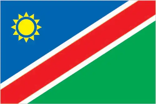Namibia’s flag features a striking diagonal red band edged in white, dividing a blue upper-left triangle—charged with a golden 12‑ray sun—and a green lower-right triangle. The design embodies unity, liberation, and natural abundance.