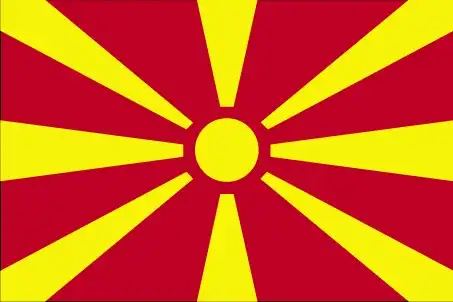 North Macedonia’s flag displays a stylized yellow sun with eight broadening rays that extend to the edges of a crimson-red field—a modern representation of the 'Sun of Liberty' rooted in national identity.