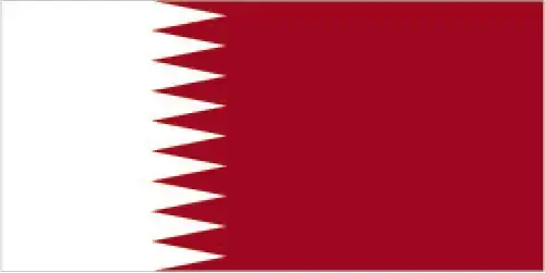 Qatar’s flag features a narrow white band at the hoist separated by nine serrated points from a wide maroon field. It has the world’s longest flag ratio and is visually distinctive in both shape and color.