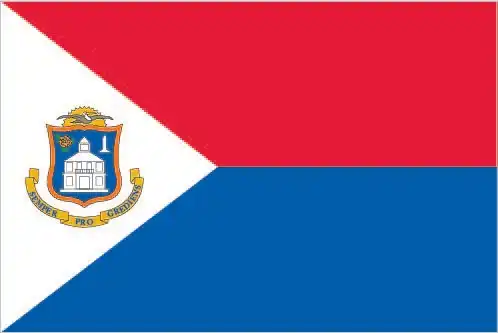 Sint Maarten’s flag is a horizontal bicolor of cherry red (top) and navy blue (bottom) with a white equilateral triangle at the hoist bearing the island’s coat of arms—reflecting local autonomy within the Kingdom of the Netherlands.
