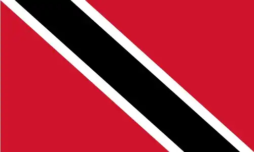 The flag of Trinidad and Tobago features a red field bisected diagonally by a wide black stripe edged in white, combining a striking design with deep symbolism rooted in natural elements.