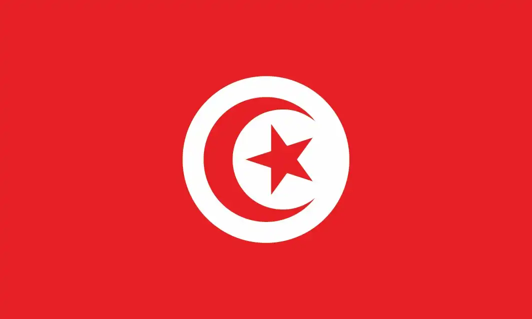 Tunisia’s flag—a red field bearing a central white disc containing a red crescent and five-pointed star—is among the oldest national flags still in continuous use, embodying Islamic symbolism and national resilience.